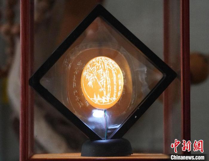 圖為吳義澤新包裝給蛋雕呈現(xiàn)立體感?！【琶赖ぴ?攝